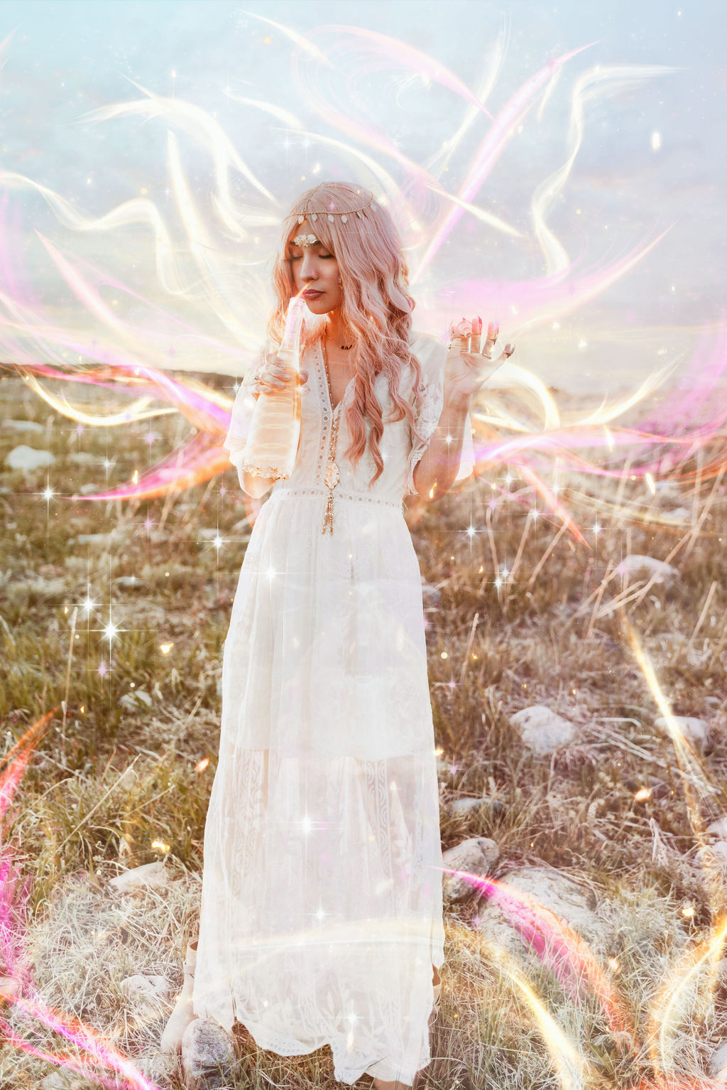 Girl with pink hair in a white dress inhales magic coming from a bottle of golden liquid as magic surrounds her for a fantasy image taken in Boulder Colorado by Kendra Colleen Photography