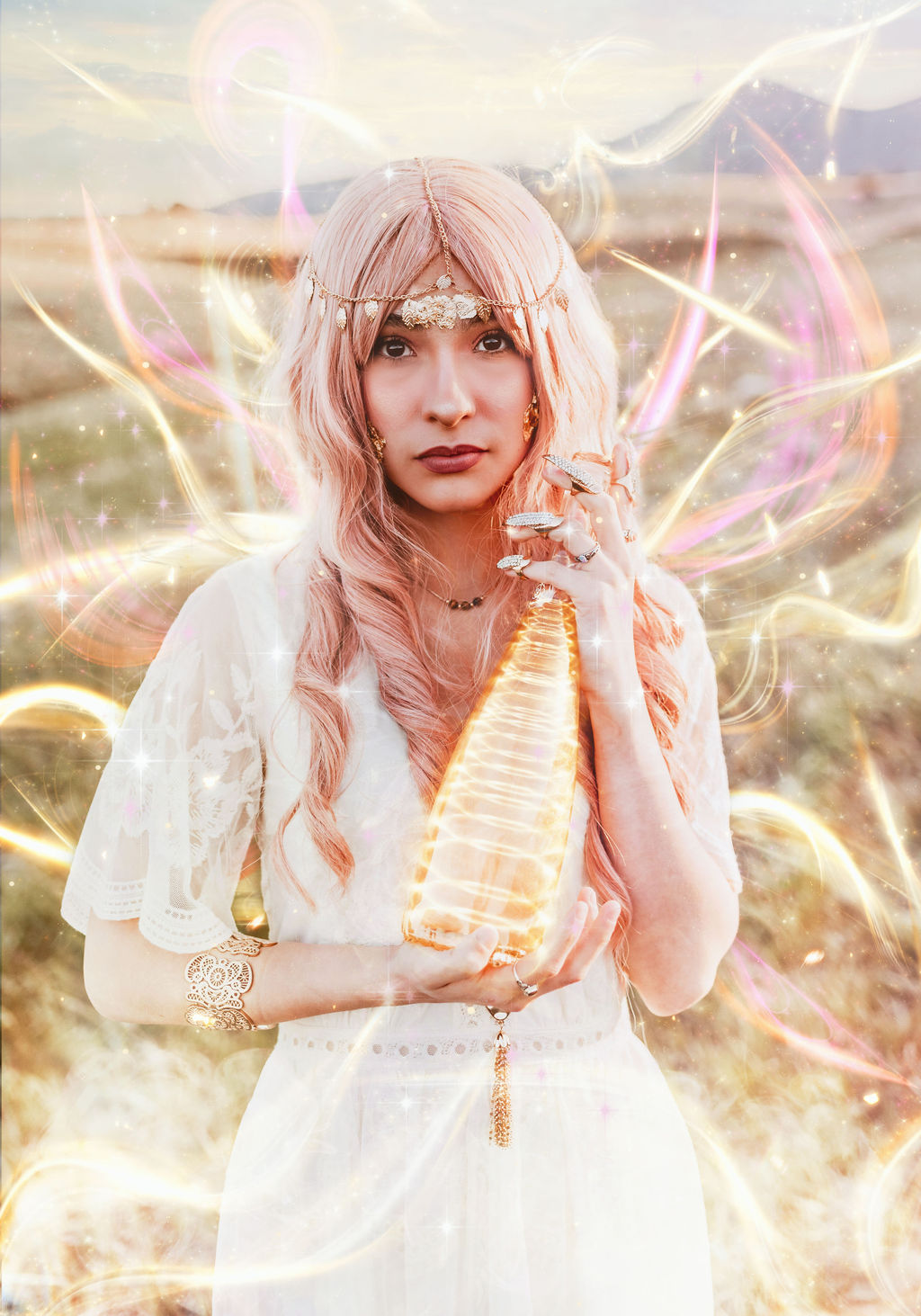Girl with pink hair holds a bottle of glowing golden liquid as magic swirls around her for a fantasy photo by Kendra Colleen Photography in Boulder Colorado